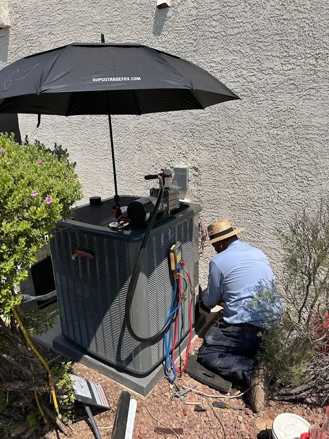 HVAC technician performing outdoor AC maintenance in Salina